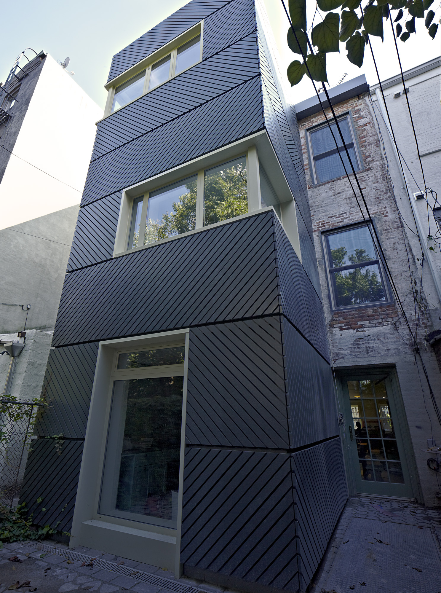 The new addition was clad in a herringbone hardiboard pattern.