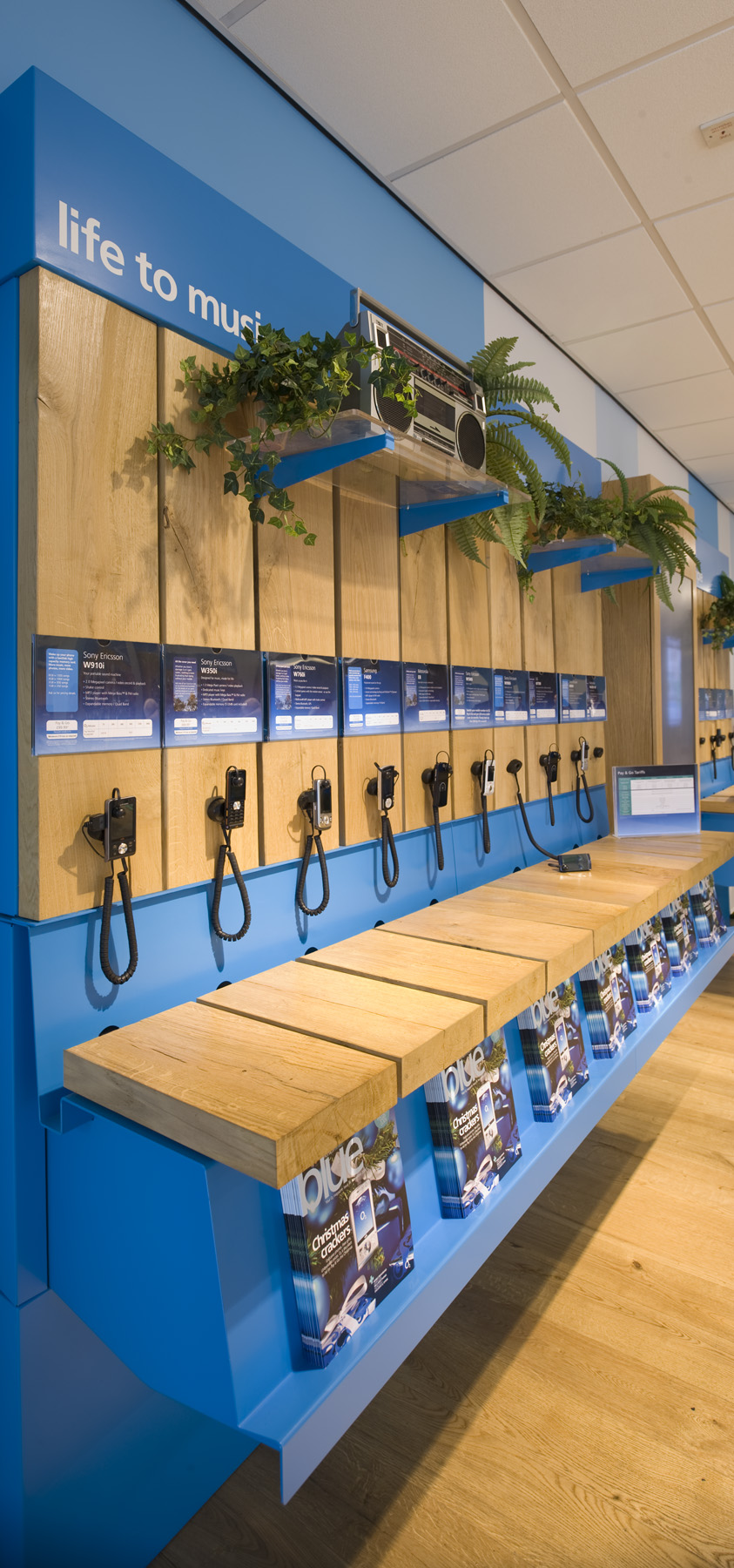 Display fixtures present working handsets in themed groupings.