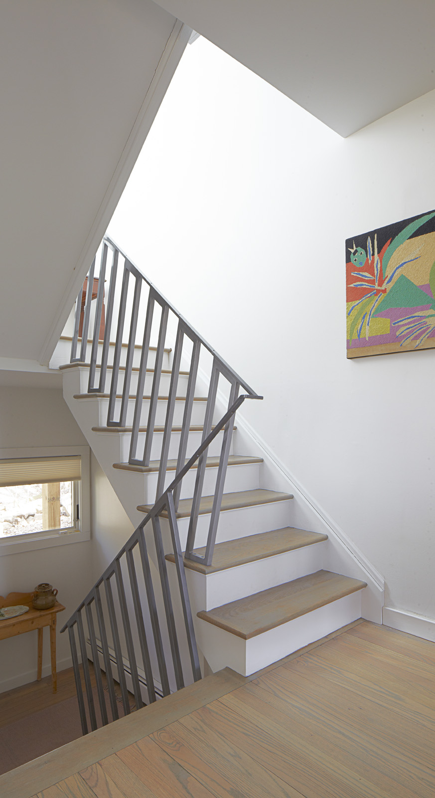 A custom designed handrail connects the old stairs with the new.
