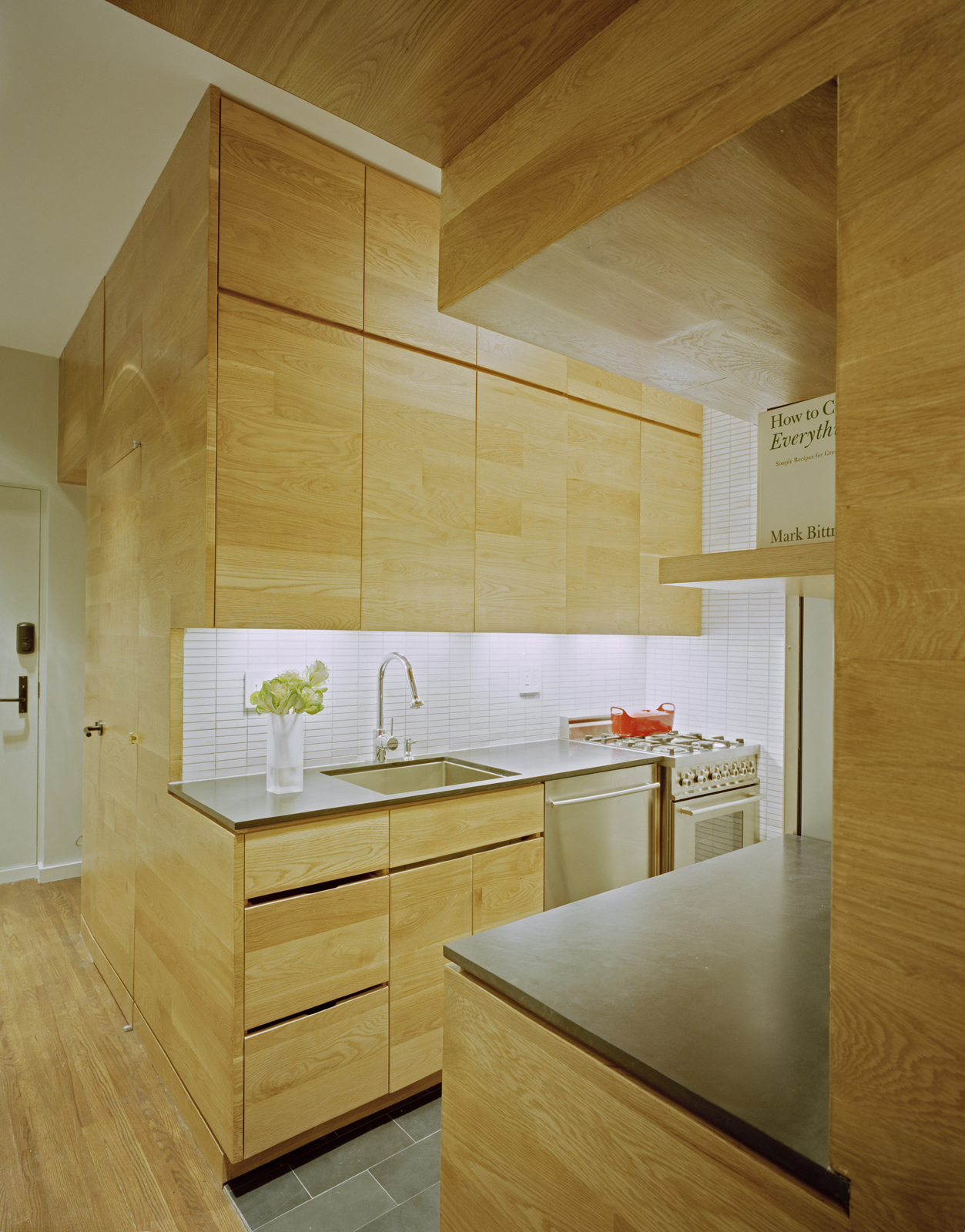 Continuous finishes hint at the tight integration of the kitchen appliances and 